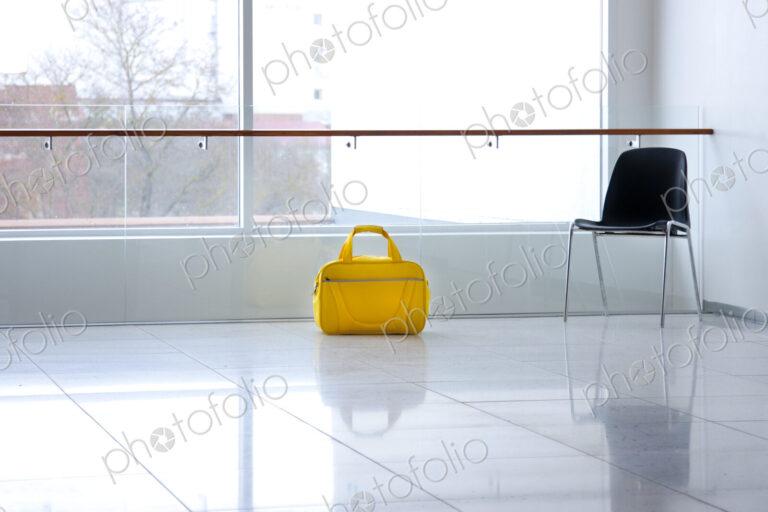 A yellow bag in a light and airy empty corridor Yellow bag.