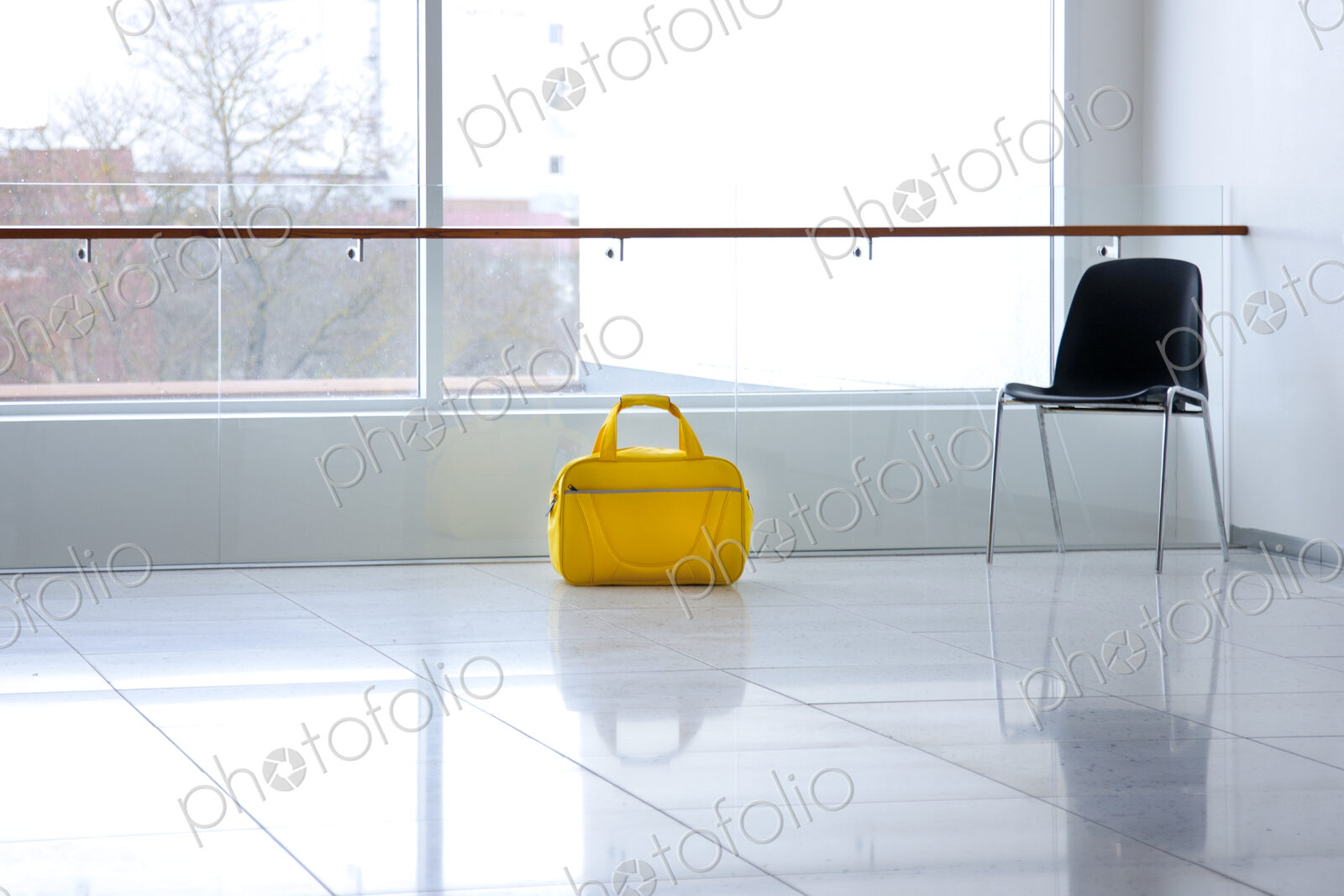 A yellow bag in a light and airy empty corridor Yellow bag.