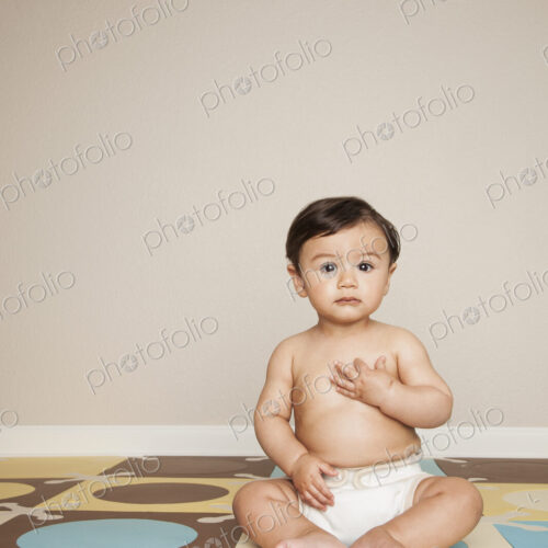 A young 8 month old baby boy wearing cloth diapers. A young 8 month old baby boy wearing cloth diapers.