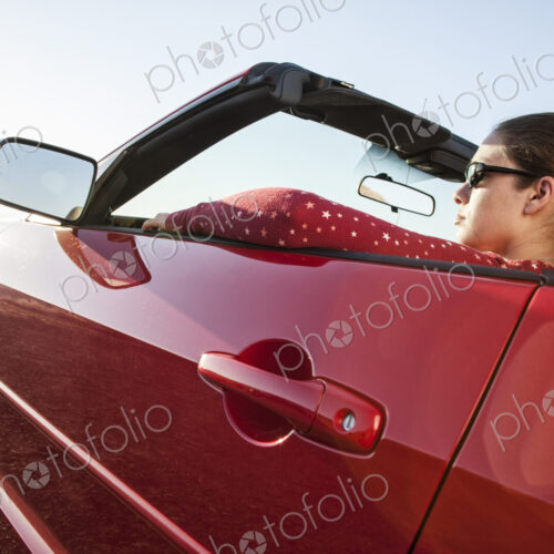 A young Caucasian woman in a convertible sports car. A young Caucasian woman in a convertible sports car.