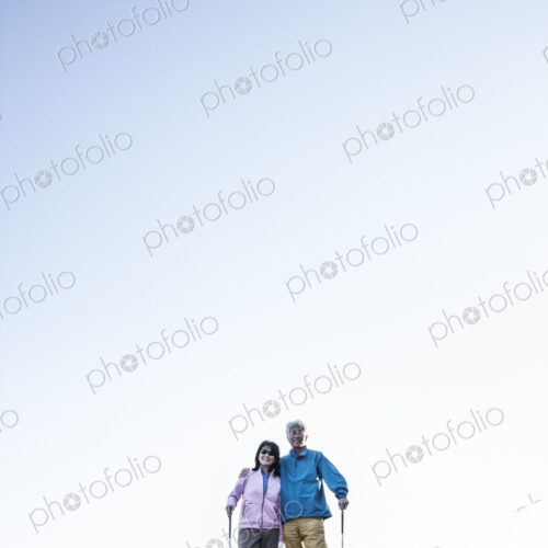 A young asian senior couple playing golf.