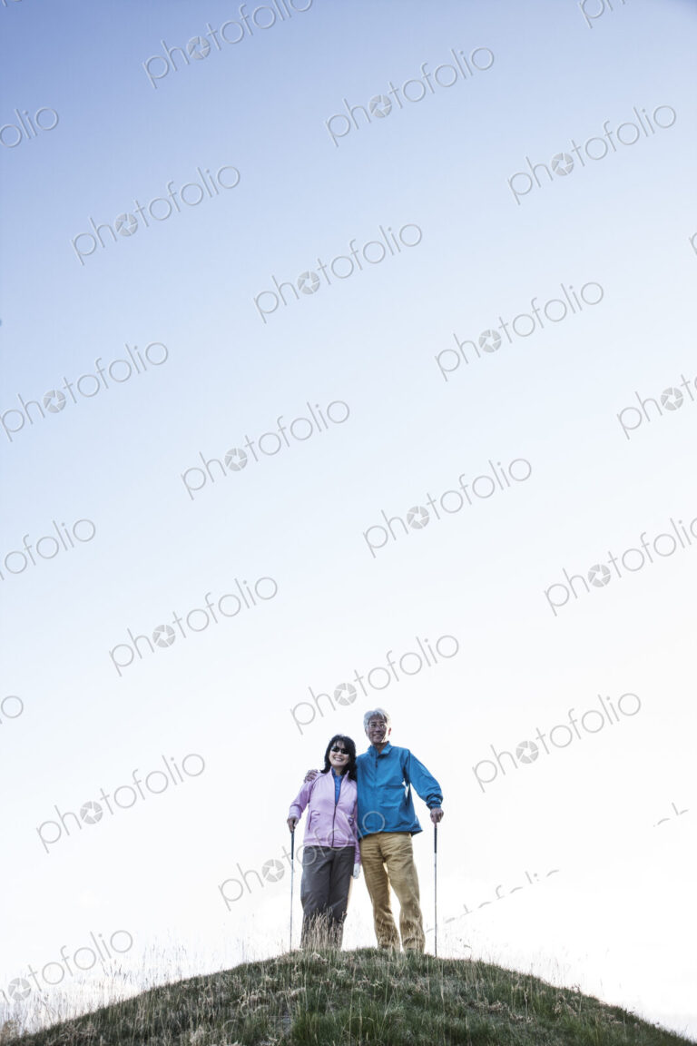 A young asian senior couple playing golf.
