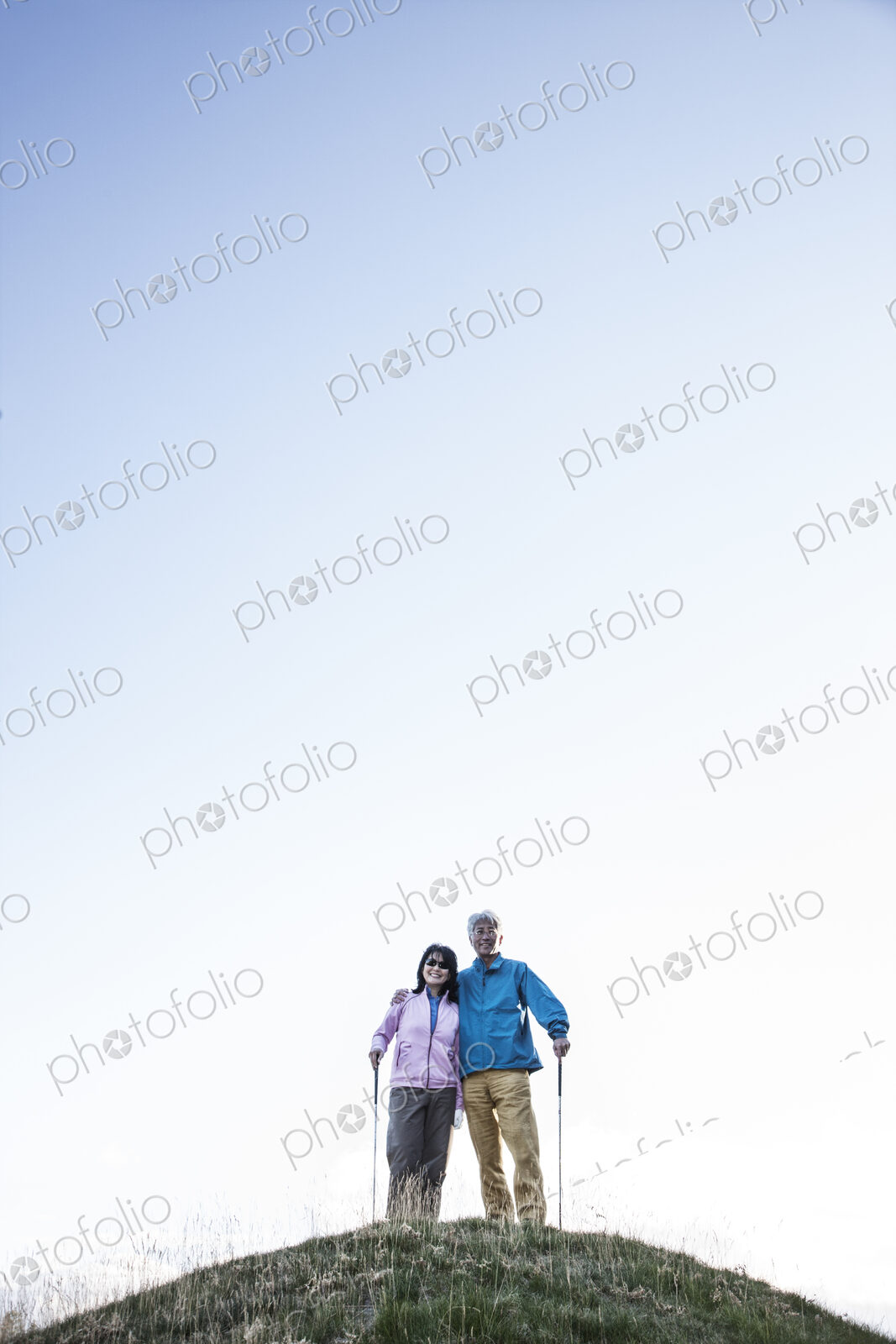 A young asian senior couple playing golf.