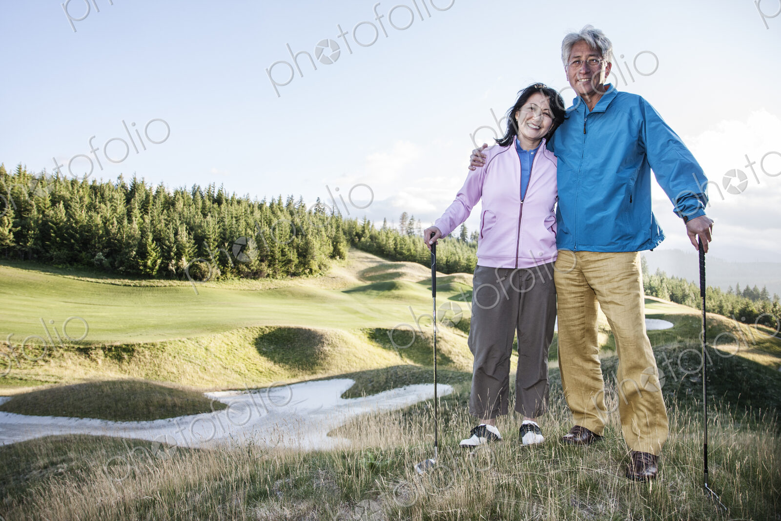 A young asian senior couple playing golf.