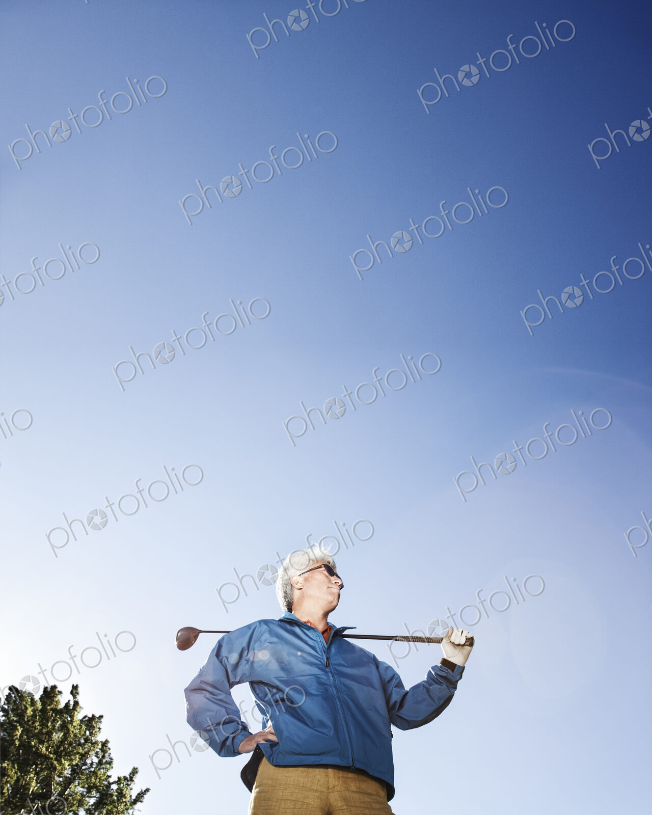 A young asian senior man ready to hit his next golf shot on a golf course.