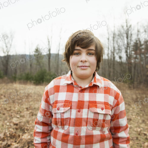 A young boy in a red checked shirt outside on a winter's day. A young boy in a red checked shirt outside on a winter's day.