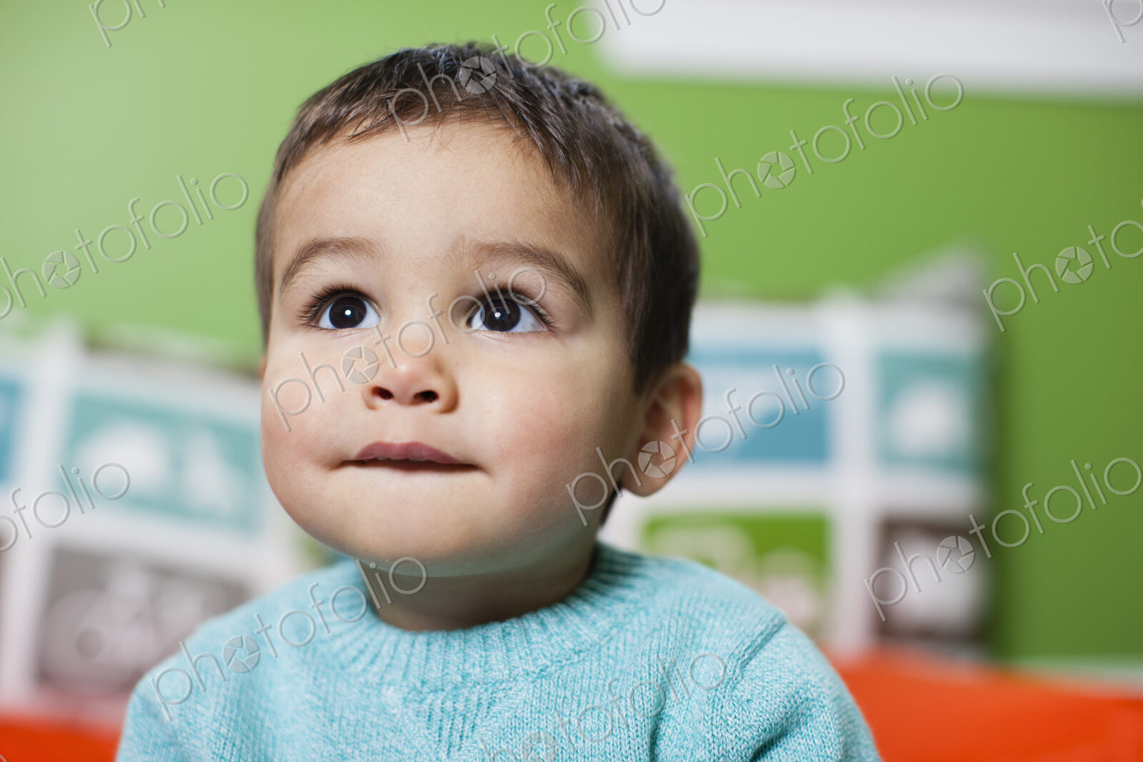 A young boy looking up with an anxious expression on his face.