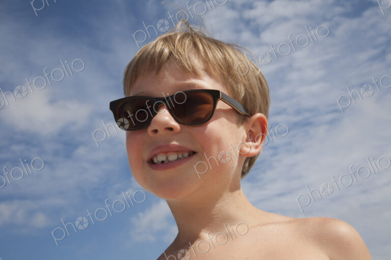 A young boy wearing sunglasses.