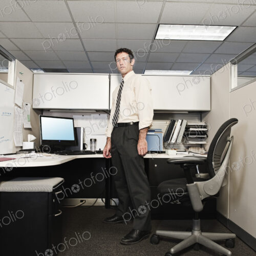 A young caucasian businessman in a shirt and tie in his office. A young caucasian businessman in a shirt and tie in his office.