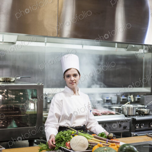 A young caucasian chef working with fresh vegetables in a commercial kitchen, A young caucasian chef working with fresh vegetables in a commercial kitchen,