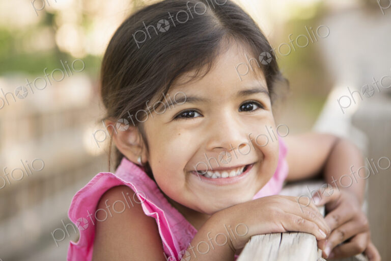 A young child, a girl smiling at the camera.