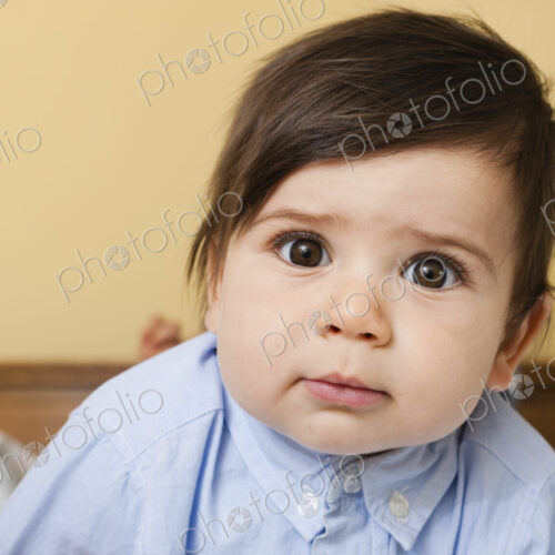 A young child with round eyes, and black hair, looking at the camera. A young child with round eyes, and black hair, looking at the camera.