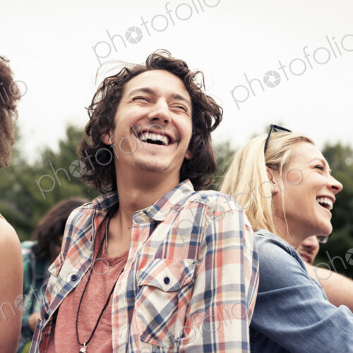 A young couple, a man and woman among others outdoors in the countryside. A young couple, a man and woman among others outdoors in the countryside.