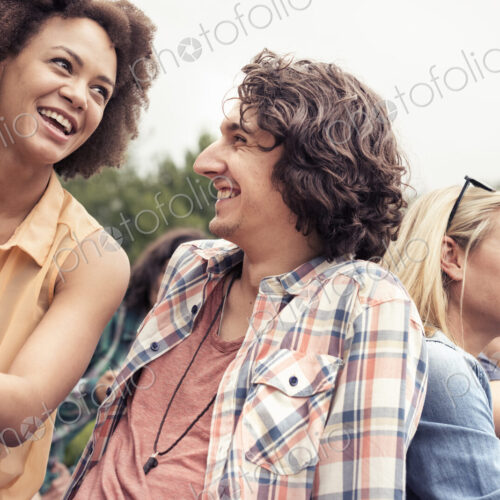 A young couple, a man and woman among others outdoors in the countryside. A young couple, a man and woman among others outdoors in the countryside.