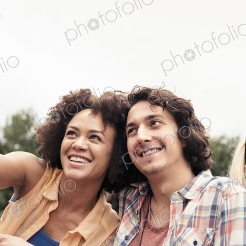 A young couple, a man and woman taking a selfie with a smart phone. A young couple, a man and woman taking a selfie with a smart phone.