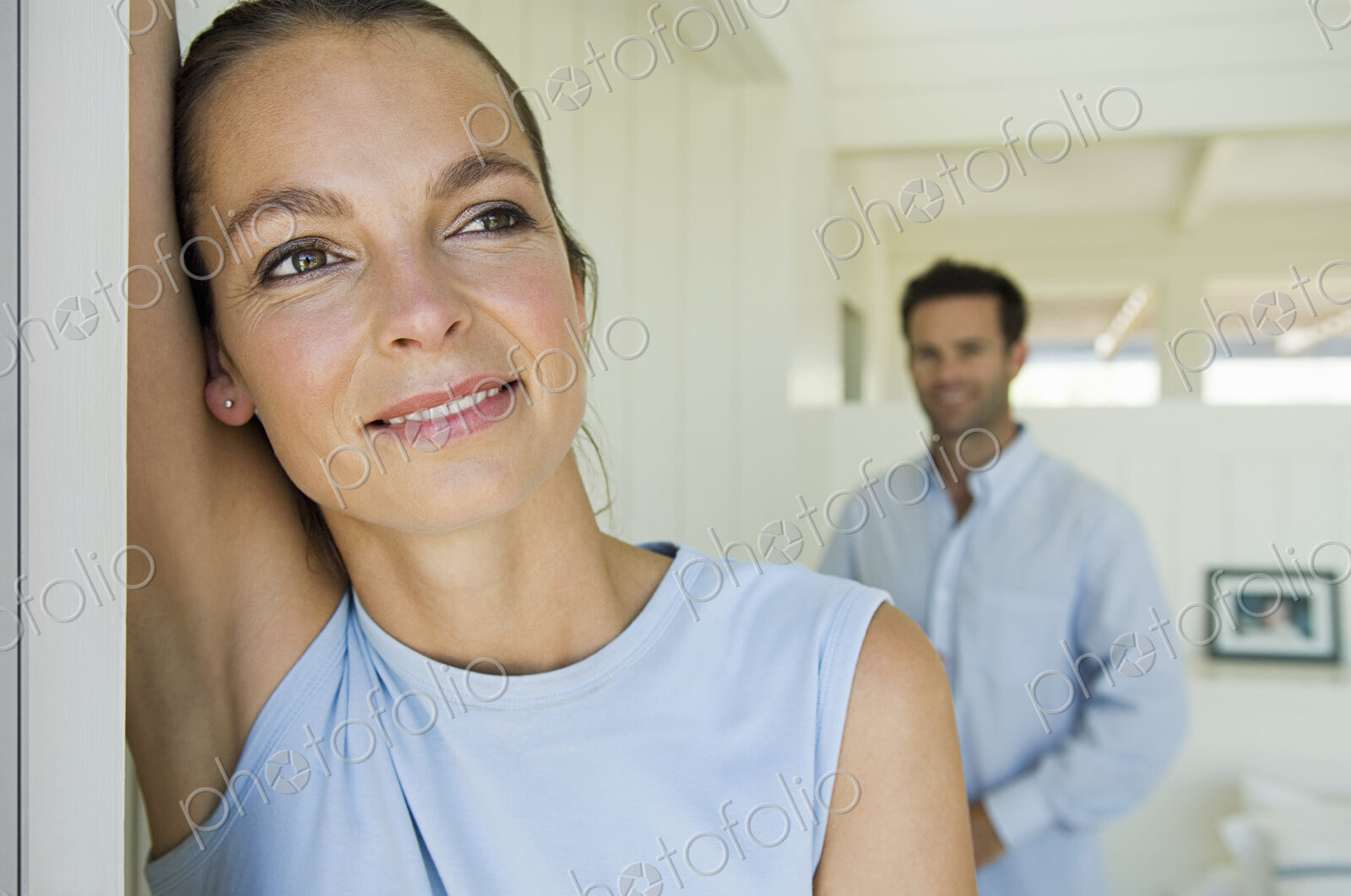 A young couple, a woman and a man at home.