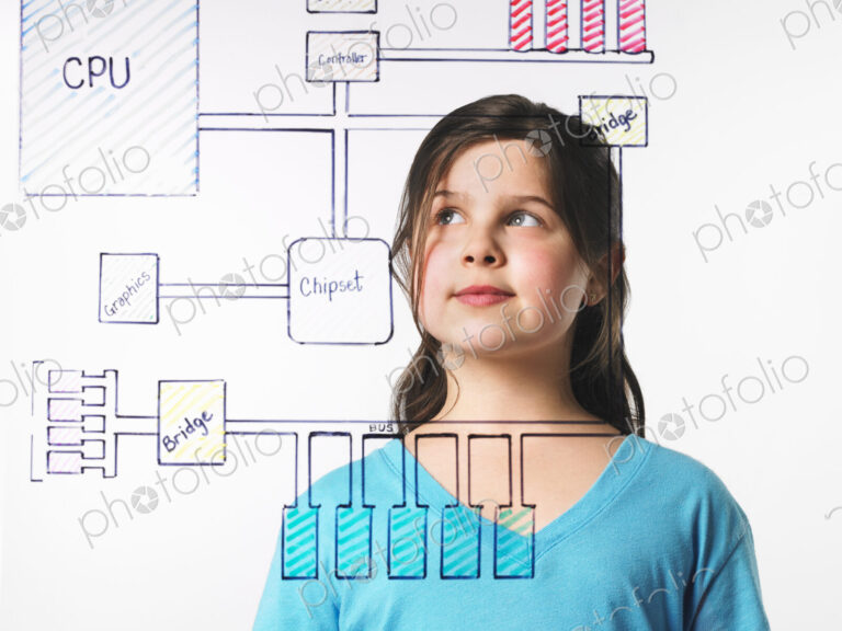 A young girl looking at a drawing of a computer motherboard circuit drawn on a see…