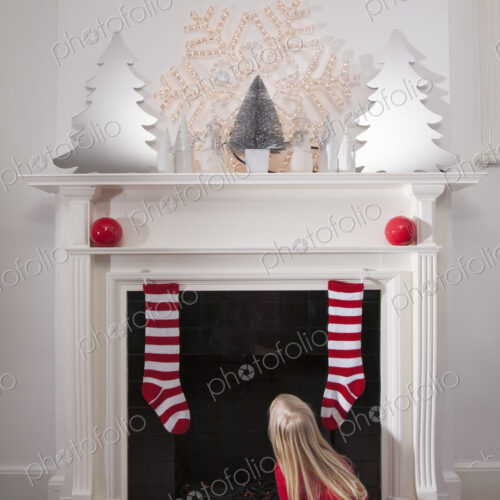 A young girl looking expectantly up the chimney awaiting the arrival of Father Christmas. A young girl looking expectantly up the chimney awaiting the arrival of Father Christmas.