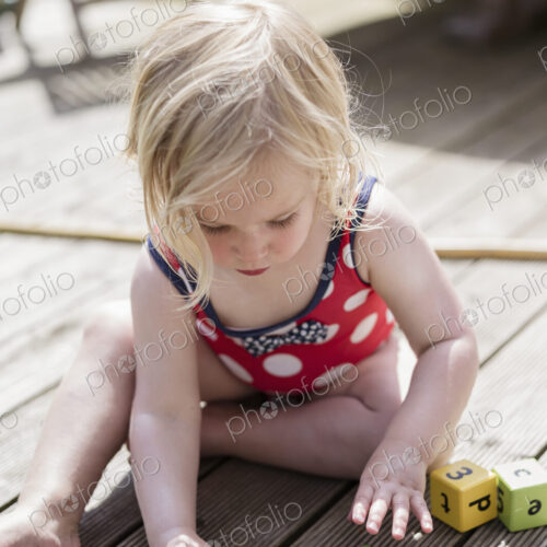 A young girl playing outdoors.
