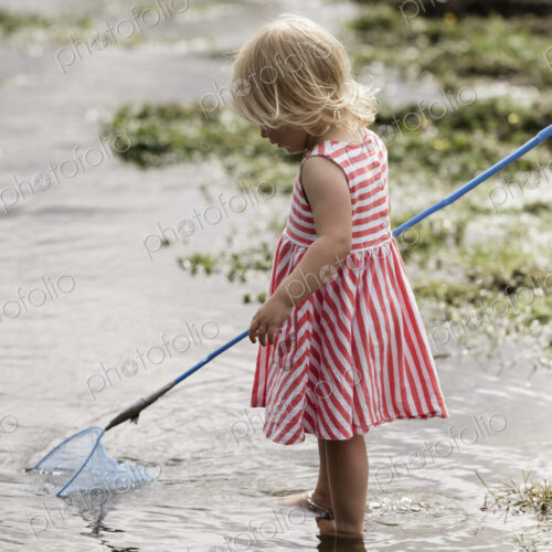 A young girl playing outdoors.