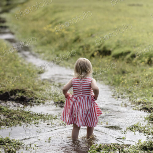 A young girl playing outdoors.