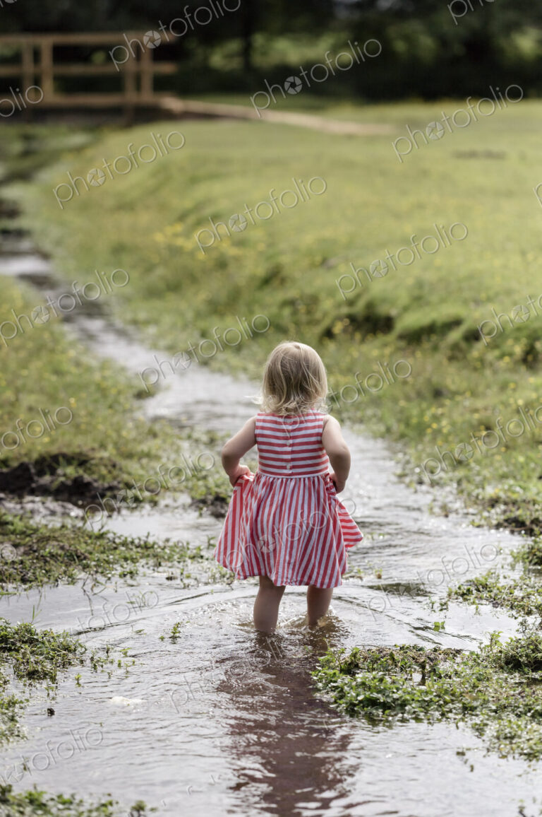 A young girl playing outdoors.