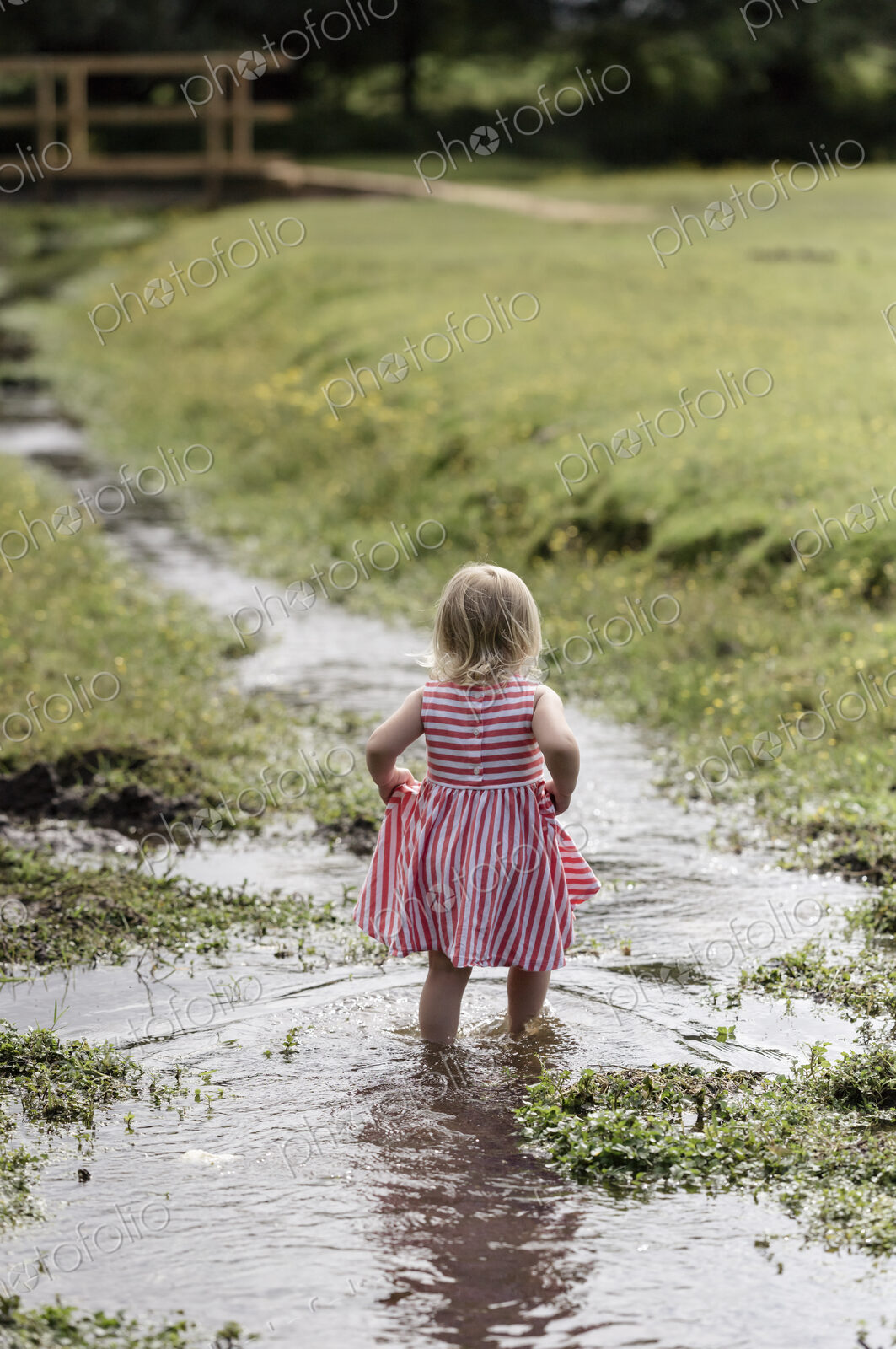 A young girl playing outdoors.