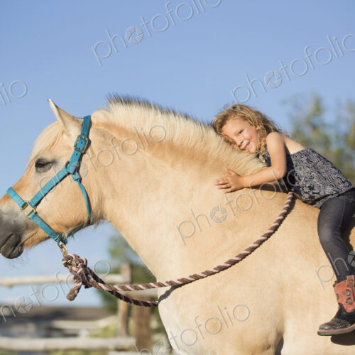 A young girl sitting on a horse. A young girl sitting on a horse.