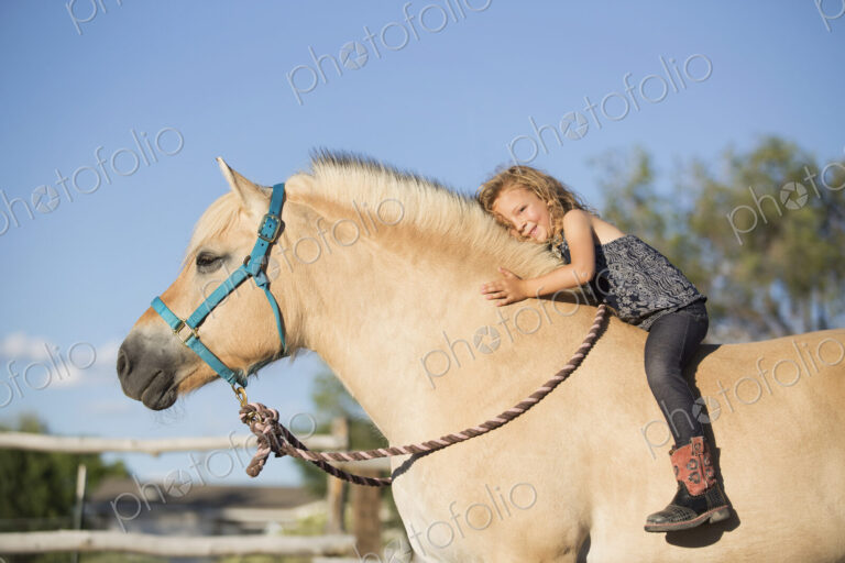 A young girl sitting on a horse.