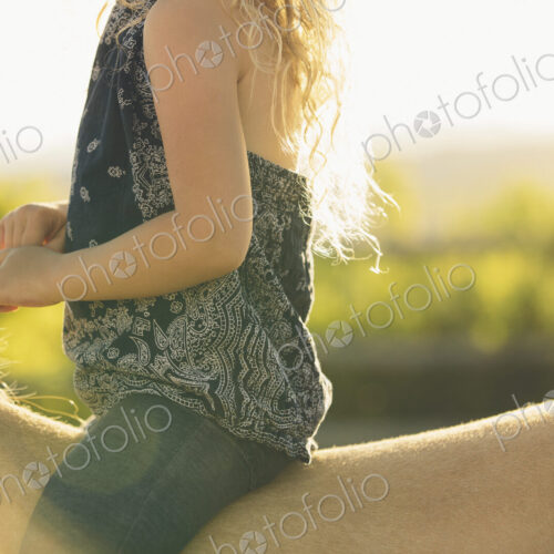 A young girl sitting on a horse. A young girl sitting on a horse.