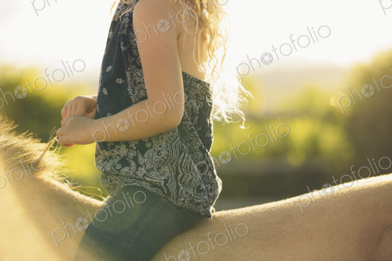 A young girl sitting on a horse.