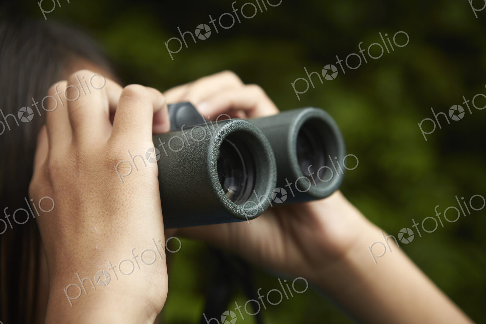 A young girl with bird watching binoculars.