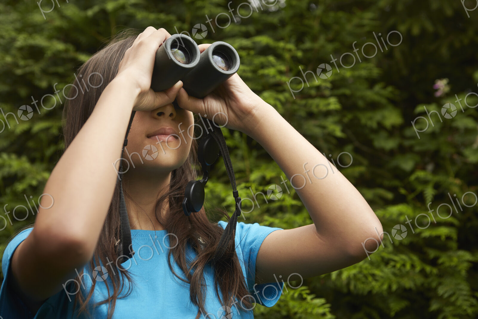 A young girl with bird watching binoculars.