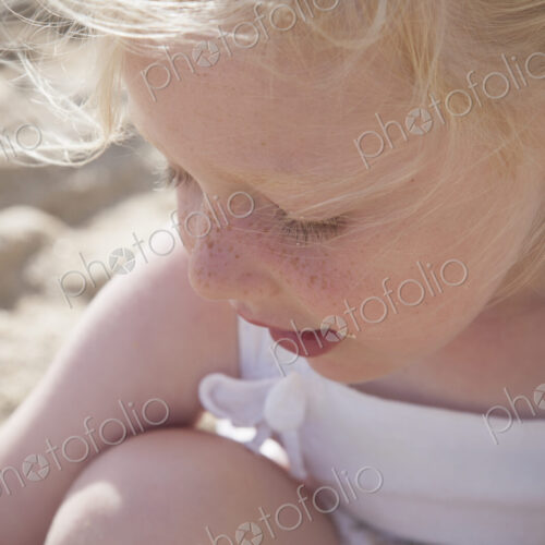 A young girl with blonde hair in pigtails on the beach. A young girl with blonde hair in pigtails on the beach.