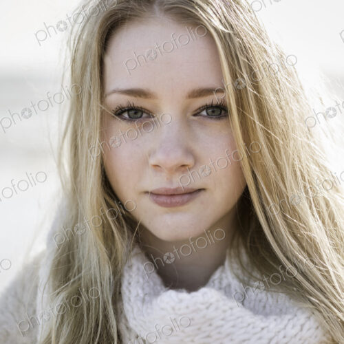 A young girl with blonde hair looking at the camera. A young girl with blonde hair looking at the camera.