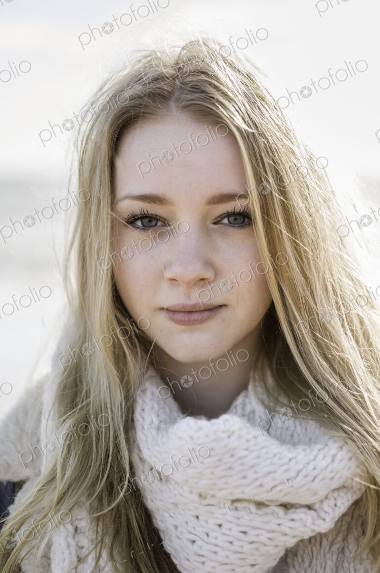 A young girl with blonde hair looking at the camera.