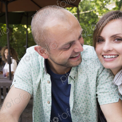 A young man and woman, a couple together at a cafe. A young man and woman, a couple together at a cafe.