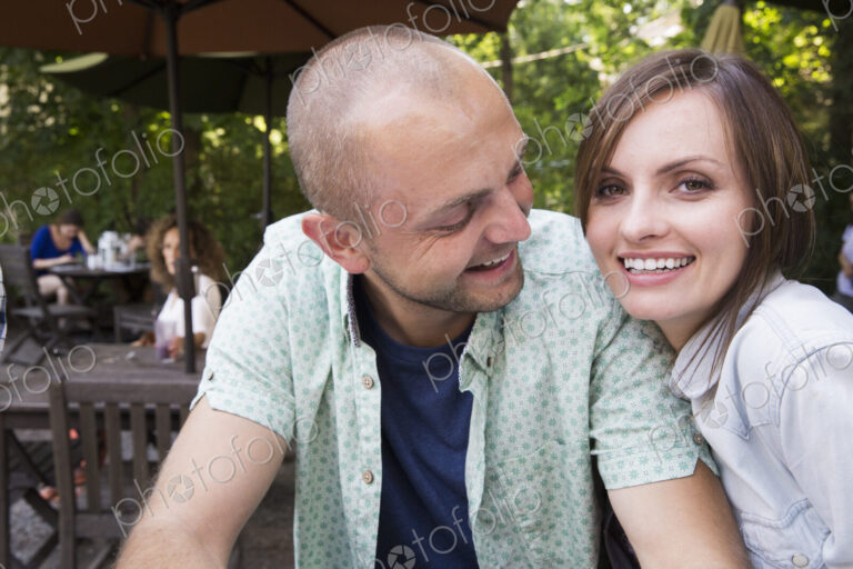 A young man and woman, a couple together at a cafe.