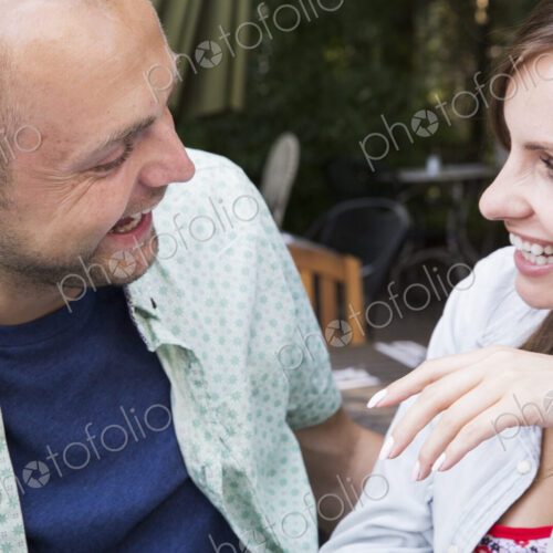 A young man and woman, a couple together at a cafe. A young man and woman, a couple together at a cafe.