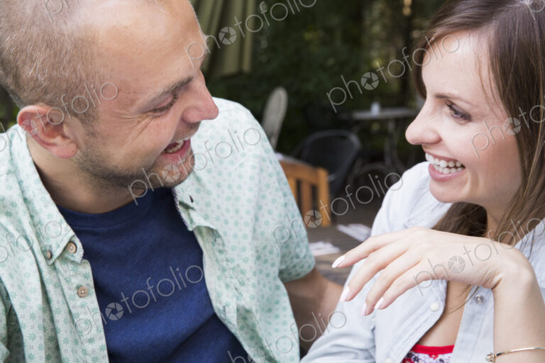 A young man and woman, a couple together at a cafe.