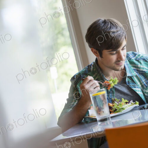 A young man using a digital tablet.