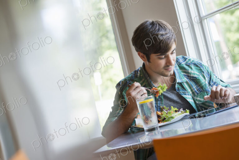 A young man using a digital tablet.