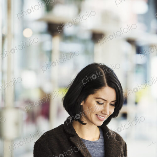 A young woman holding at a cellphone and smiling. A young woman holding at a cellphone and smiling.