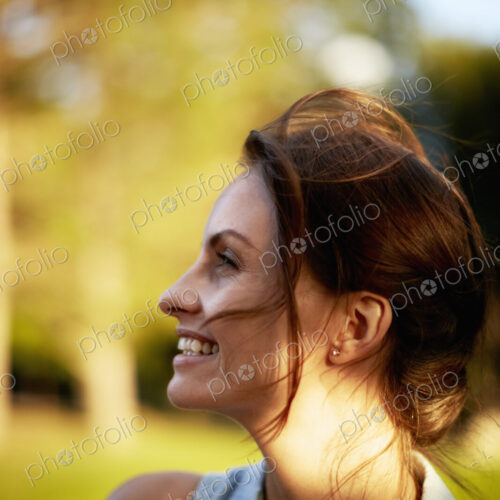 A young woman in the woods at dusk.