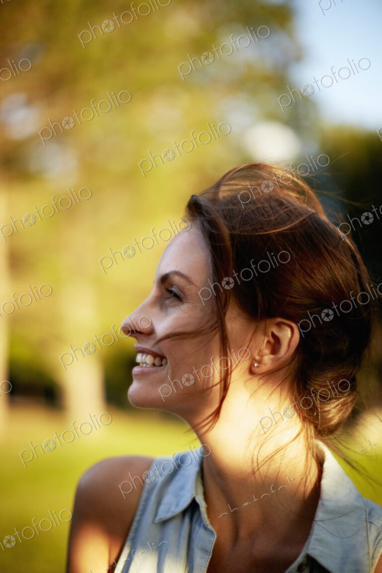 A young woman in the woods at dusk.