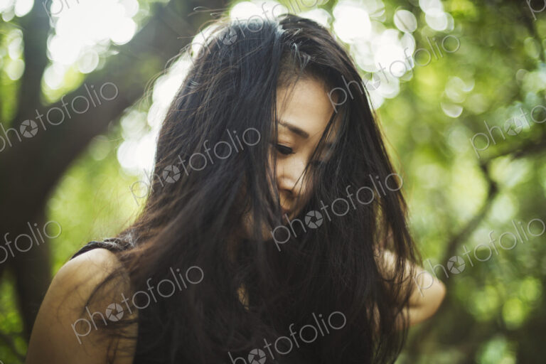 A young woman in woodland, outdoors.