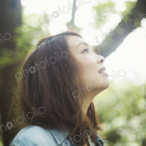 A young woman in woodland, outdoors. A young woman in woodland, outdoors.