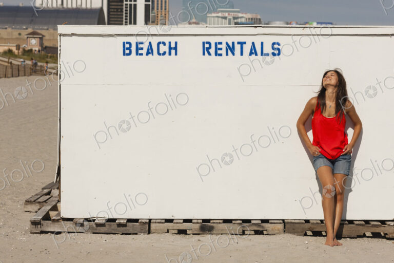 A young woman on the boardwalk at Atlantic City, in New Jersey, by the Beach Rentals…