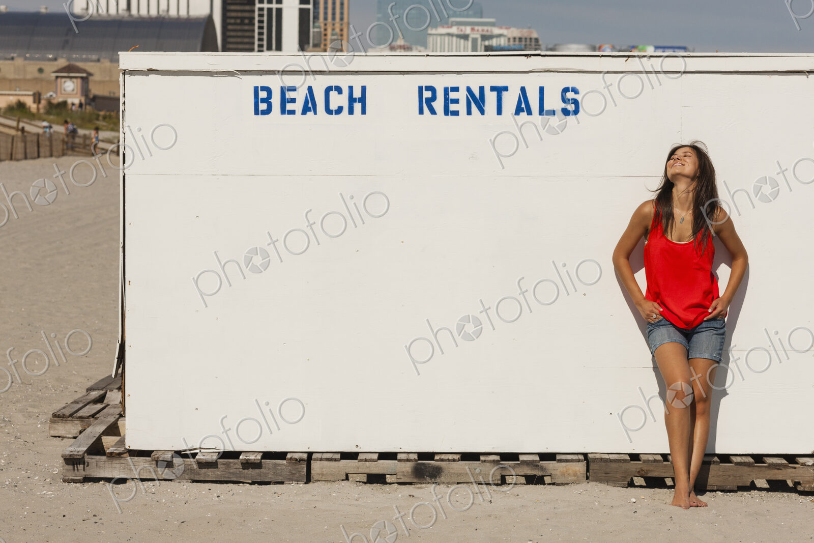 A young woman on the boardwalk at Atlantic City, in New Jersey, by the Beach Rentals…