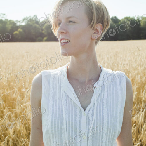 A young woman standing in a cornfield looking around her, A young woman standing in a cornfield looking around her,